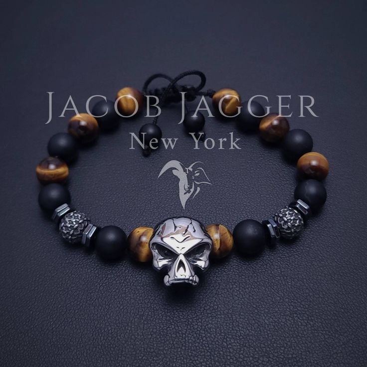 Gothic style stainless steel skull bracelet for men. Adjustable length mens tiger eye and matte black onyx bracelet made with natural 8mm stone beads, and silver stainless steel charms. SIZE GUIDE: Check 5th picture for size instructions. GIFT BOX: Bracelets are shipped in 1 gift box. If you prefer boxes for each bracelet, leave a message BEFORE shipping labels are created. Black Skull Bracelets For Streetwear, Box Bracelets, Black Onyx Bracelet, Skull Bracelet, Onyx Bracelet, Skull Jewelry, Shipping Labels, Bracelet For Men, Gothic Style