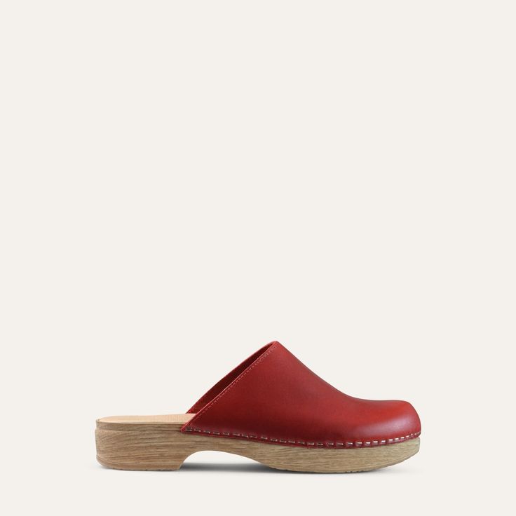 Helena red leather clog Casual Closed Toe Clogs With Branded Insole, Classic Slip-on Clogs With Rubber Sole, Leather Sole Slip-on Clogs With Plain Toe, Comfortable Flat Clogs With Rubber Sole, Branded Insole Slip-on Flat Clogs, Red Slip-on Mules With Leather Footbed, Classic Leather Clogs With Flat Heel, Classic Slip-on Clogs With Leather Sole, Casual Clogs With Red Sole And Round Toe