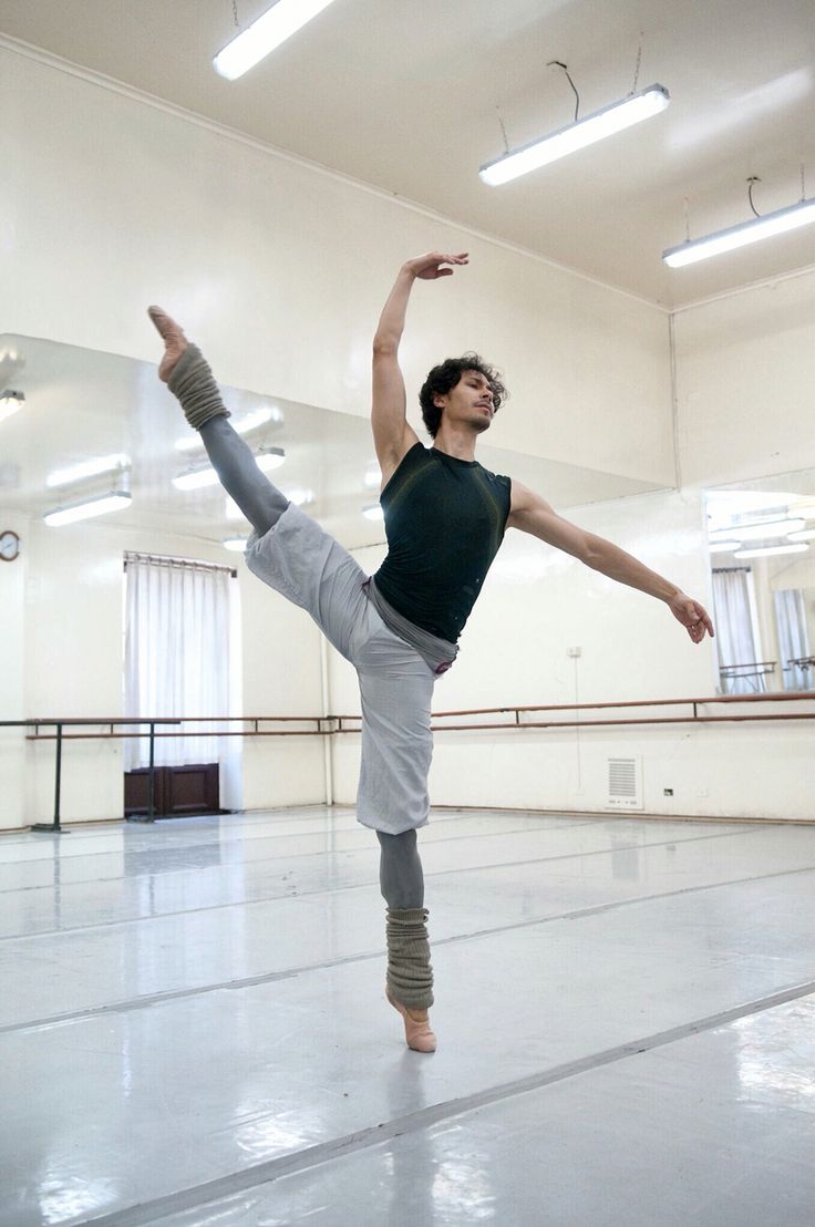 a man is doing an acrobatic move in the middle of a dance studio