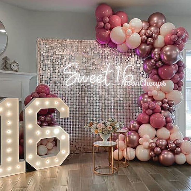 a room decorated with balloons and lights for a sweet 16 birthday party or bridal