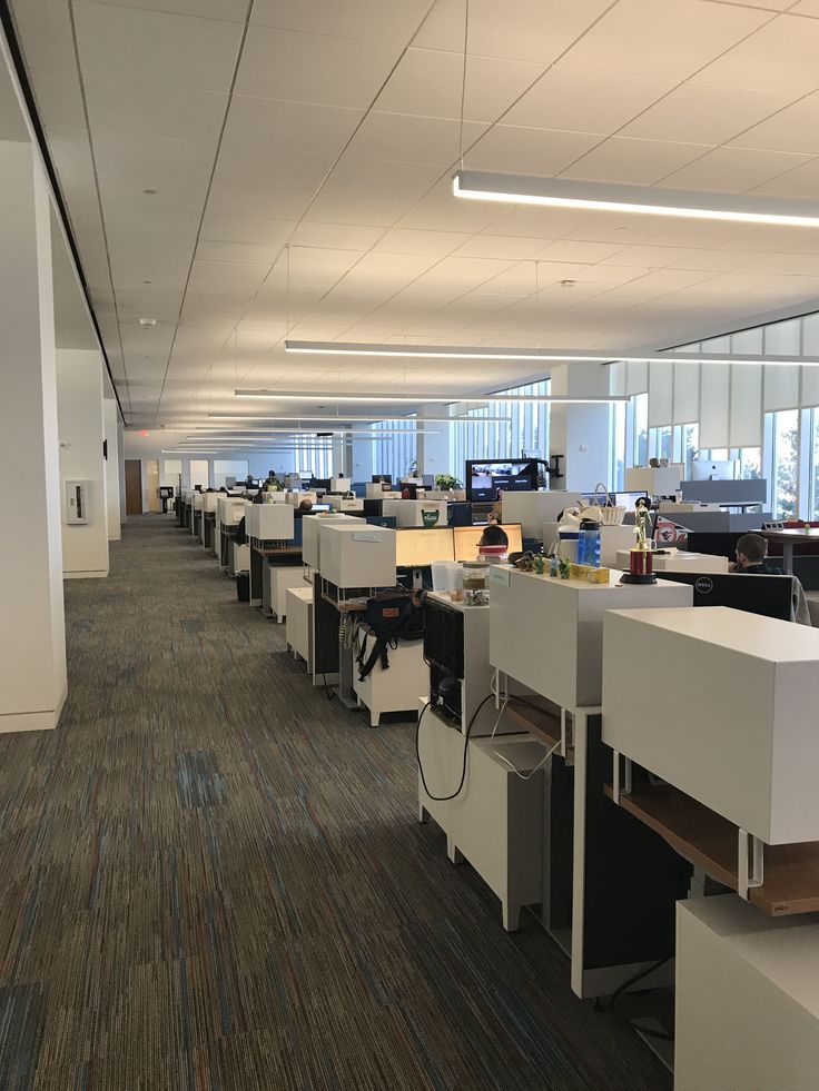 an empty office with cubicles and desks