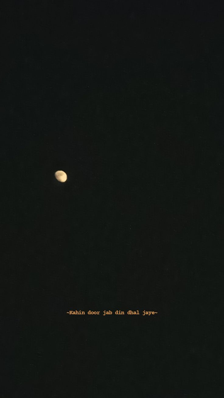 the moon is seen in the dark sky with an inscription written on it's side