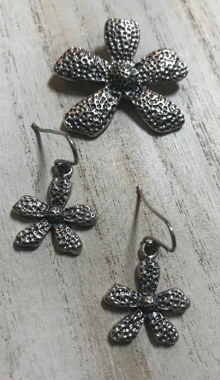 "Silpada 925 Sterling Silver Textured Flower Earrings W1155 and Daisy Pendant S1101 Set HTF Approximately 3/4 inches in length on French wires. . Can be found in the 2006-2007 catalog page 58. Both items has the Silpada signature arrowhead logo ans 925 stamp of quality! In Excellent Condition! Retired Silpada stamped flower pendant, approximately 1 1/2\" in length, Can be found in the 2007-2008 catalog page 68H This set is intentionally oxidized. items will be sent in a gift bag with an anti tar Silver Flower Jewelry With Matching Earrings, Silver Flower-shaped Metal Earrings, Silver Flower Pendant Jewelry With Matching Earrings, Silver Oxidized Flower Jewelry, Silver Flower Jewelry With Oxidized Finish, Silver Adjustable Flower Earrings, Adjustable Silver Flower Earrings, Silver Metal Flower Earrings With Ear Wire, Silver Flower Earrings With Ear Wire