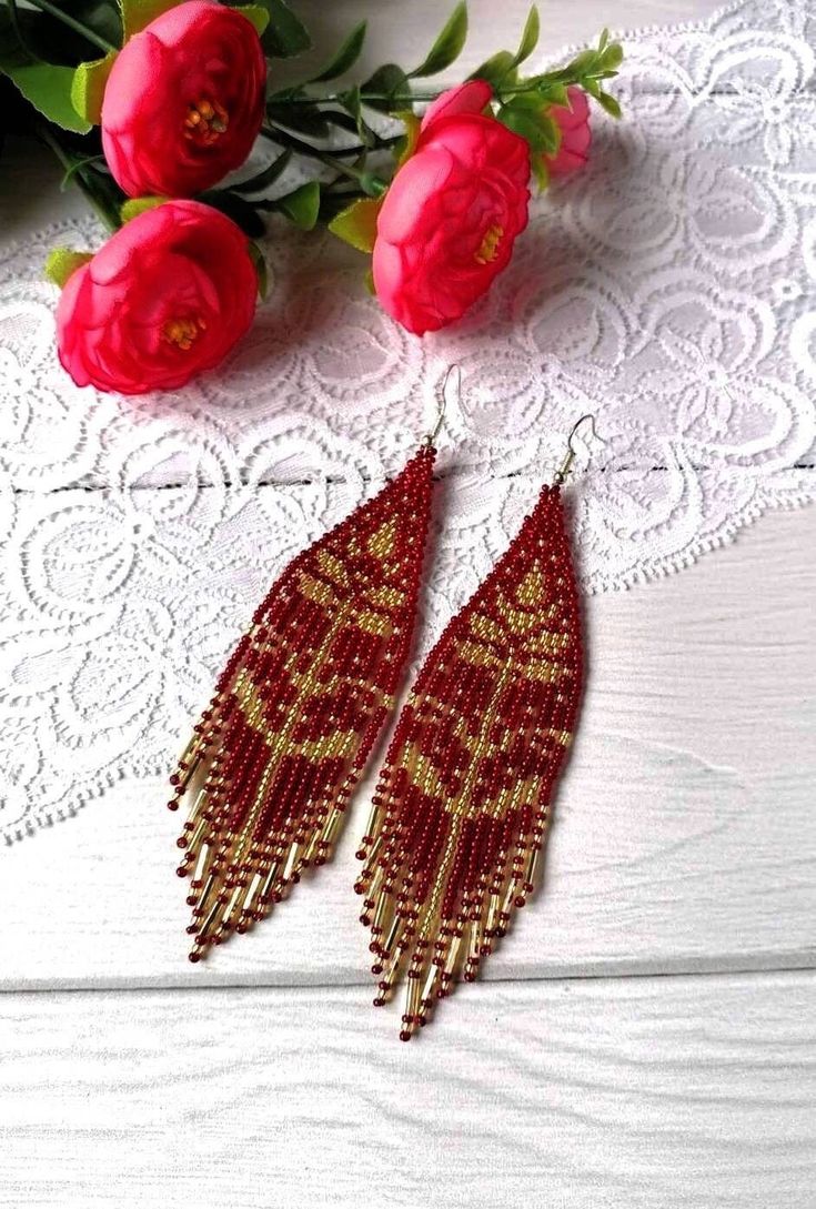 "These red gold beaded earrings pair amazingly with any outfit, dressy or casual. They are made of high-quality Czech colored beads with Surgical steel ear hooks . Colors:red gold Length: 5 inches (12.5 cm) Width: 1.1 inches (3 cm) Materials: Czech \"Preciosa\" beads Durable synthetic thread steel ear hooks" Cheap Red Flower Shaped Beaded Earrings, Elegant Beaded Earrings With Dangling Beads For Festivals, Elegant Dangling Beads Earrings For Festivals, Elegant Dangling Beaded Earrings For Festivals, Red Bohemian Beaded Earrings With Gold Beads, Bohemian Red Beaded Earrings With Gold Beads, Handmade Red Tassel Earrings, Elegant Style, Red Gold Beaded Drop Earrings, Handmade Elegant Red Tassel Earrings