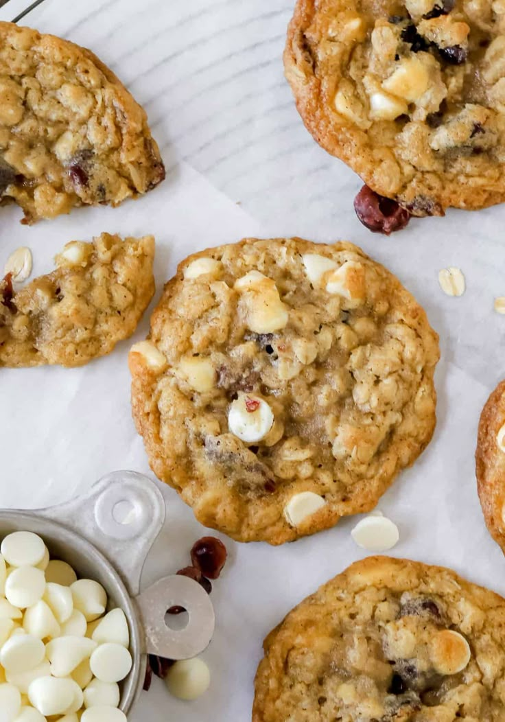 cookies and marshmallows are arranged on top of a white paper towel next to a bowl of chocolate chips