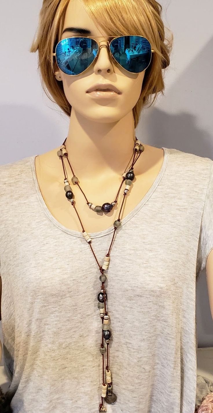 LARGE PEACOCK PEARLS Large freshwater peacock pearls, African old Nigerian rustic glass goomba beads and gray beach glass beads. Artfully combined and knotted on natural brown genuine leather with vintage coin on the end. Tie this necklace several ways to get the the most from a single piece of jewelry. You'll want this unique necklace next time you stroll along the coast! • Wear With Different Necklines. • Genuine Cultured Pearls• 60" Long You can have the charm engraved with one initial. Just Bohemian Single Strand Lariat Beaded Necklaces, Bohemian Single Strand Lariat Beaded Necklace, Bohemian Long Necklace With Natural Stones For Layering, Rustic Adjustable Beaded Necklaces, Brown Long Necklace For Beach, Bohemian Brown Lariat Beaded Necklaces, Bohemian Lariat Necklace With Round Beads, Bohemian Single Strand Lariat Necklace With Round Beads, Bohemian Adjustable Lariat Necklace With Gemstone Beads