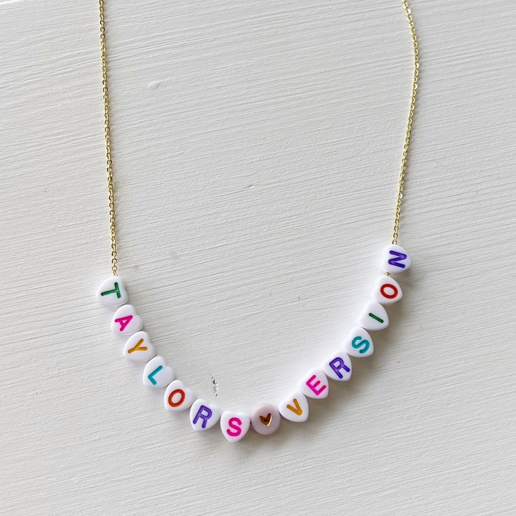 Always choose Taylor's version! You can showcase your favorite song or album with this personalized necklace! Cute little letter beads strung on either a dainty 24k gold or silver chain - perfect for any mood or outfit! Our resident Swiftie has assembled some options that perfectly depict each era for you to use as examples. {Thanks Ali!} *Personalize this necklace with your favorite song or album *This necklace measures 18" Everyday Adjustable Custom Name Charm Necklaces, Everyday Adjustable Charm Necklaces With Custom Name, Everyday Adjustable Charm Necklace With Custom Name, Everyday Adjustable Custom Name Charm Necklace, Trendy Personalized Everyday Charm Necklace, Trendy Personalized Initial Necklace For Everyday, Dainty Customized Name Necklace For Everyday Wear, Dainty Customized Name Necklace For Everyday, Trendy Personalized Necklaces For Everyday