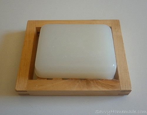 a square white object in a wooden holder