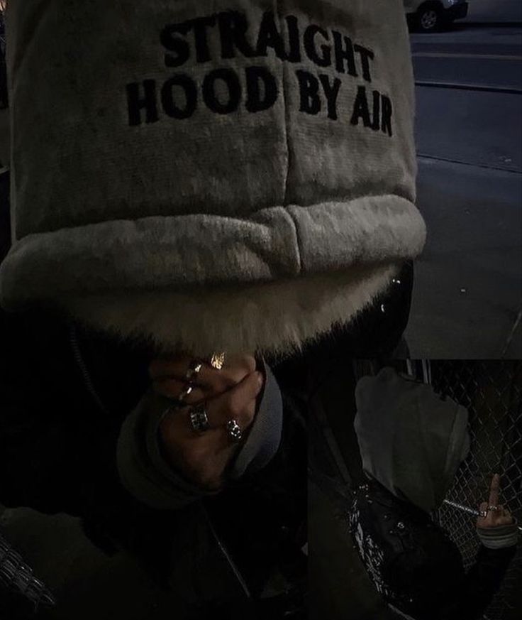 a person wearing a hat with the words straight hood by air on it's side