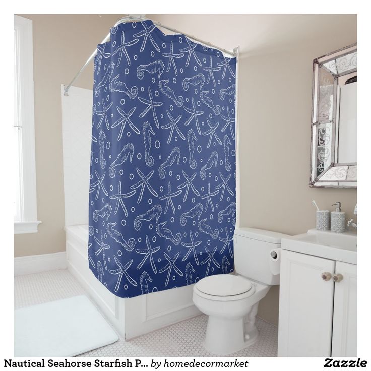 a bathroom with a blue shower curtain and white toilet in front of a sink vanity