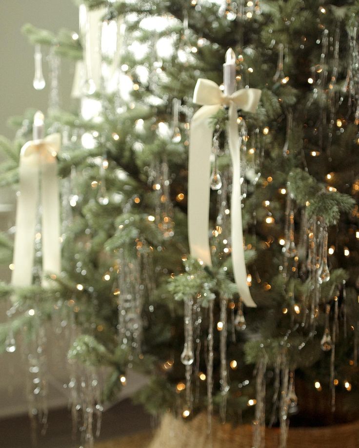 a christmas tree with white bows and lights