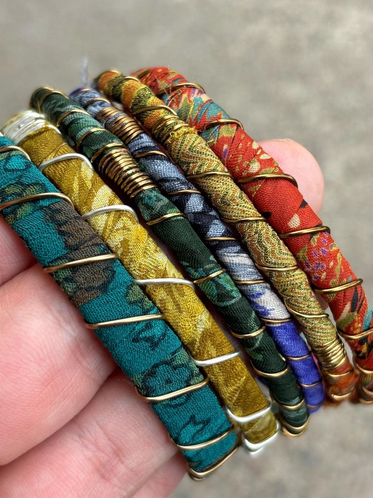 Stack up on these colorful & bold boho bangles!  I wrap each bracelet by hand with unique upcycled sari silk and finish with a wire wrap to secure.  Add vintage kuchi coin charms to a few or all to complete the look, These bracelets are a super simple and lightweight for easy, comfortable wear. Select one or mix and match to create your own personalized set! ★ Handmade ★ Upcycled Sari Silk ★ Non-Tarnish Wire ★ Vintage Kuchi Coin Charm ★ 65mm inner diameter ✉ Message for Custom Requests ✈ Free Sh Bohemian Hand-wrapped Bracelets For Festivals, Handmade Bohemian Bangle As Gift, Green Bohemian Wrap Bracelet For Festival, Bohemian Handmade Friendship Bracelets For Festivals, Multicolor Bohemian Bracelets For Festivals, Multicolor Bohemian Bracelet For Festivals, Bohemian Multicolor Bracelets For Festivals, Artisan Hand Wrapped Wrap Bracelet For Festivals, Artisan Hand-wrapped Wrap Bracelet For Festivals