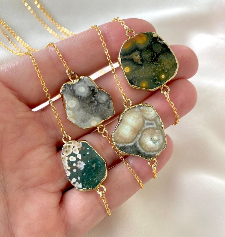 **Each piece in my shop, I personally create and photograph. (All photos are property of The Cord Gallery LLC) Thank you for supporting my small business. Freeform Agate Slice Necklaces These stunning necklaces add a touch of nature and beauty to any outfit! Features genuine Agate pendants that have been sliced and framed and plated in a 24k gold finish. Hangs on your choice of Gold plated or Gold filled chain.  **Select your exact stone and chain length at checkout. Chain length choices: 16 inc Bohemian Gold Jewelry With Moss Agate, Bohemian Ocean Jasper Jewelry For Gifts, Bohemian Ocean Jasper Jewelry As Gift, Bohemian Ocean Jasper Jewelry Gift, Adjustable Ocean Jasper Necklaces With Natural Stones, Bohemian Ocean Jasper Necklaces For Gifts, Bohemian Ocean Jasper Necklaces As Gifts, Ocean Jasper Gemstone Jewelry For Gifts, Bohemian Ocean Jasper Necklace For Gifts