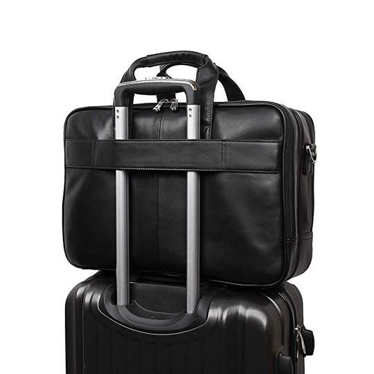 two pieces of luggage are stacked on top of each other, one is black and the other is silver