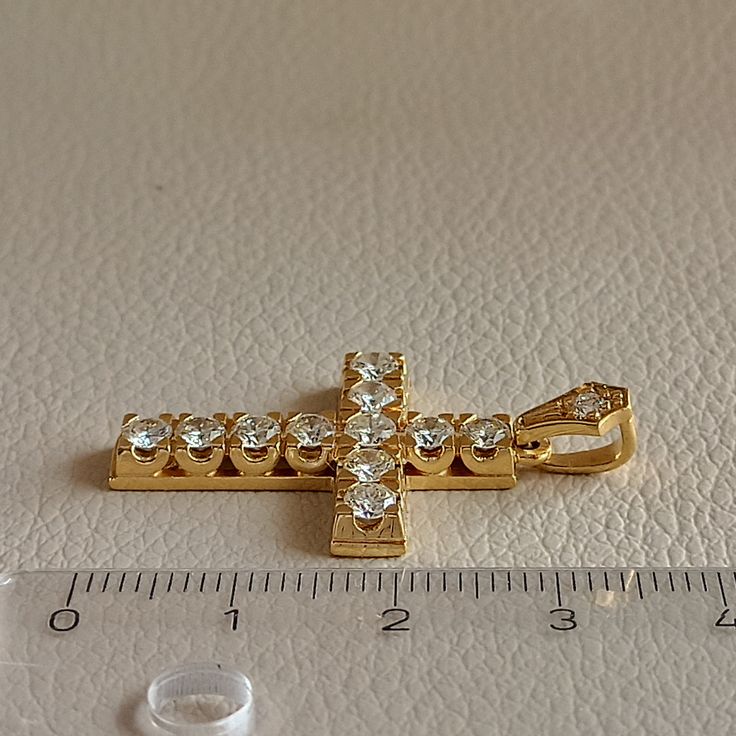 Cross made of 18 ct. yellow gold with natural diamonds On the Cross there is 11 diamonds weighing 0.14 ct. each and a diamond on the hanger weighing 0.04 ct. The total weight of all the diamonds is 1.58 ct. They are natural diamonds ( Not man made diamonds ) Color grade of the stones is J-K and clarity grade VS I It's an elegant handmade Cross made in Greece in our workshop in Athens. Ideal for Baptism, Engagement Anniversary, and any other special occasion ( The price does not include the chain Gold Pendant Jewelry With Prong Setting, Gold Pendant With Prong Setting, 14k Gold Jewelry With Single Cut Diamonds, Dazzling Gold Jewelry With Diamond Cut, Dazzling Gold Diamond Cut Jewelry, Dazzling Diamond Cut Gold Jewelry, Formal Gold Jewelry With Brilliant Cut, Dazzling Gold Jewelry With Diamond Accents, Gold Plated Diamond Accented Jewelry In Diamond White