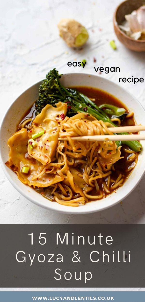 a white bowl filled with noodles and broccoli next to some chopsticks