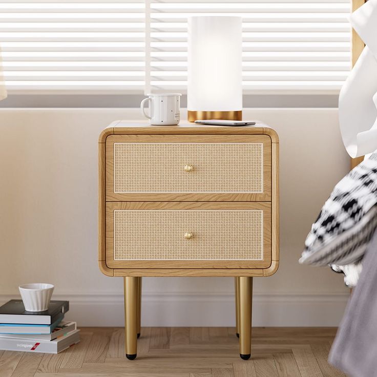 a bedside table with two drawers and a lamp on top