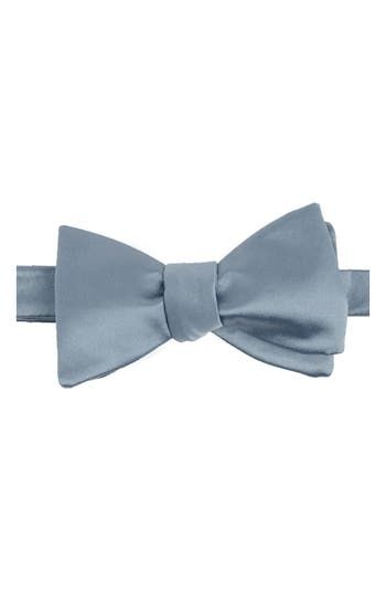 Bring versatility and distinction to any formal look with this bow tie crafted in a solid color from smooth and silky satin.  2 5/8" width 40" length 100% polyester Dry clean Imported Classic Solid Color Bow With Ties, Classic Solid Bow Tie, Classic Solid Suit And Tie Accessories With Decorative Bow, Solid Black Tie With Decorative Bow, Classic Pre-tied Satin Bow, Elegant Solid Bow Tie, Classic Adjustable Satin Ties, Elegant Solid Color Bow With Tie Back, Business Ties With Decorative Bow