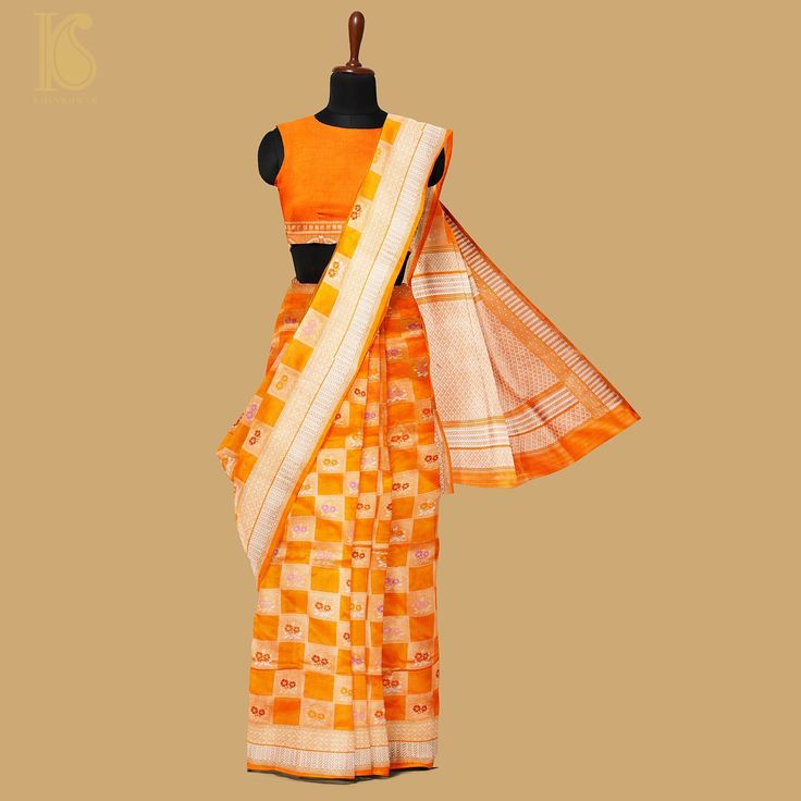 Khinkhwab's Katan Silk saree epitomizes timeless grace and luxury. Meticulously crafted with pure silk, the fabric boasts a smooth and lustrous texture, highlighting the traditional Katan weave known for its fine and tight pattern. This saree offers an elegant drape and a luxurious feel against the skin. Khinkhwab's Katan Silk saree is a fusion of heritage and modern sophistication. Each piece tells a story of craftsmanship and attention to detail, making it a symbol of refinement. Experience th Traditional Orange Pre-draped Saree With Zari Weaving, Orange Handloom Pre-draped Saree For Puja, Orange Handloom Art Silk Pre-draped Saree, Elegant Unstitched Saree With Woven Motifs, Orange Handloom Pre-draped Saree, Orange Slub Silk Traditional Wear, Classic Traditional Wear With Traditional Drape For Festive Occasions, Classic Festive Traditional Wear With Traditional Drape, Orange Handloom Blouse Piece In Traditional Drape