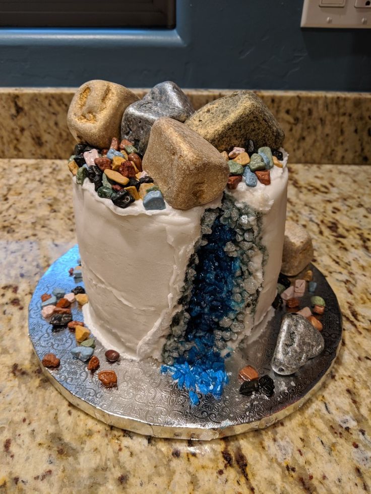 there is a cake that has been made to look like rocks and pebbles on it