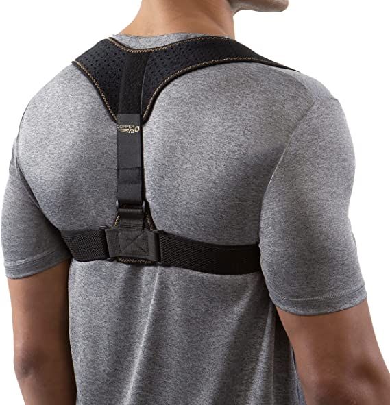 a man in grey shirt wearing a back support device with black straps on his shoulder