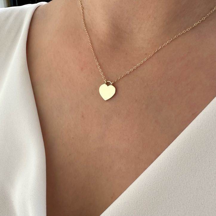 14K Gold Heart Necklace, Minimalist Love Necklace, Wedding Gift The heart shape is universally recognized as a symbol of love and affection. Wearing heart jewelry can indicate a romantic relationship, deep emotional connection, or a loving sentiment toward someone as well as self-love and self-care. Heart jewelry, especially when given as a gift, can symbolize a commitment to a romantic partner or a pledge of loyalty and devotion. It might also represent the idea of giving one's heart to another Pledge Of Loyalty, Relationship Necklaces, Gold Dainty Necklace, Romantic Partner, Romantic Relationship, Heart Shaped Jewelry, Turtle Necklace, Dainty Gold Necklace, Gold Heart Necklace