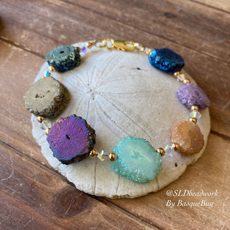 Stalactite bracelet crystal druzy pendants sliced raw gemstone jewelry hippie festival bracelet gold bohemian gift unique jewelry for women Length: 7 inches This summer bracelet beauty full of energy has multi color treated 14-20mm Stalactites druzy coin raw cut breads, 4mm Swarovski Crystals, gold plated findings and lobster closure. Stalactites are formed into crystal in caves with dripping water over years and years. These are treated into different colors. Perfect for something different in Festival Armband, Festival Bracelets, Dripping Water, Red Coral Earrings, Jewelry Hippie, Raw Gemstone Jewelry, Summer Bracelet, Armband Gold, Beaded Jewelry Necklaces