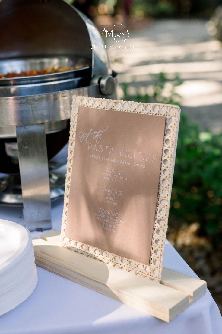 a table topped with a sign next to a grill