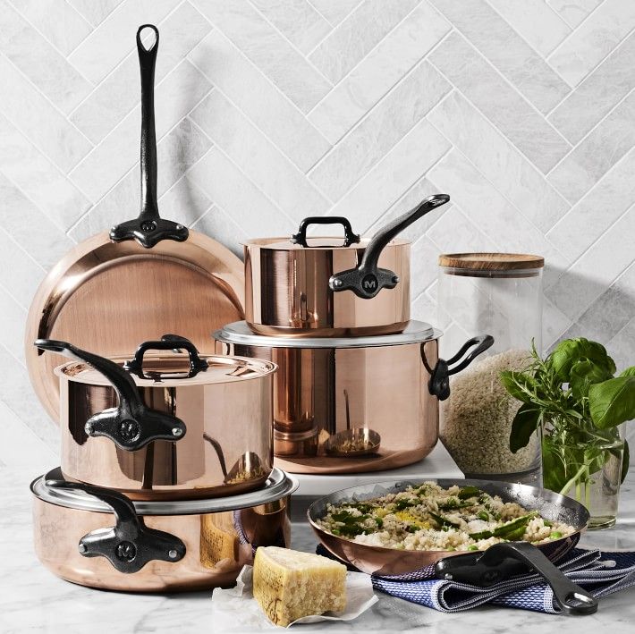 several pots and pans on a marble counter top