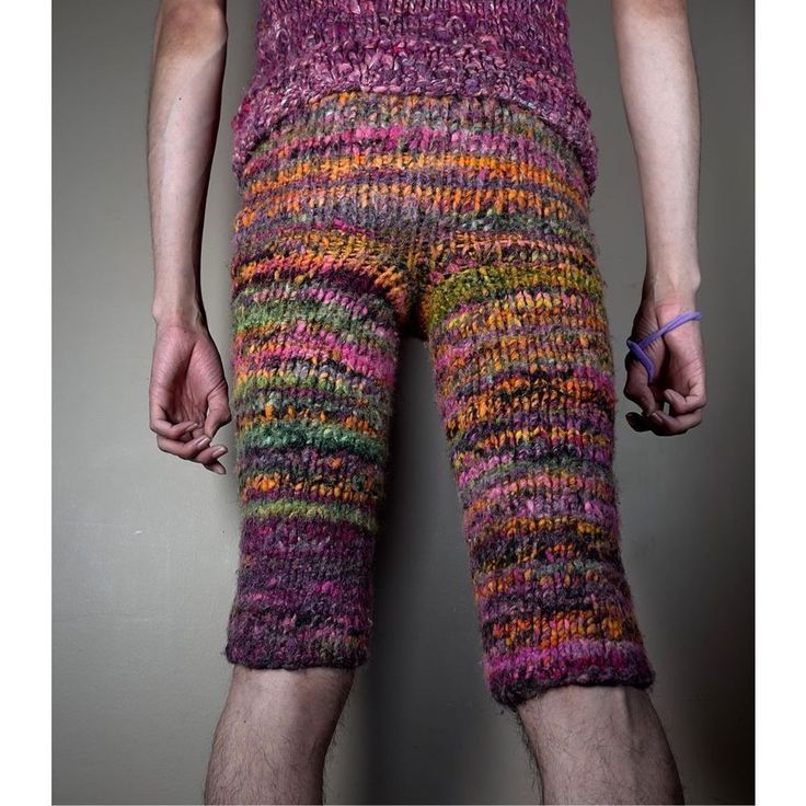 a man wearing colorful knitted shorts and socks