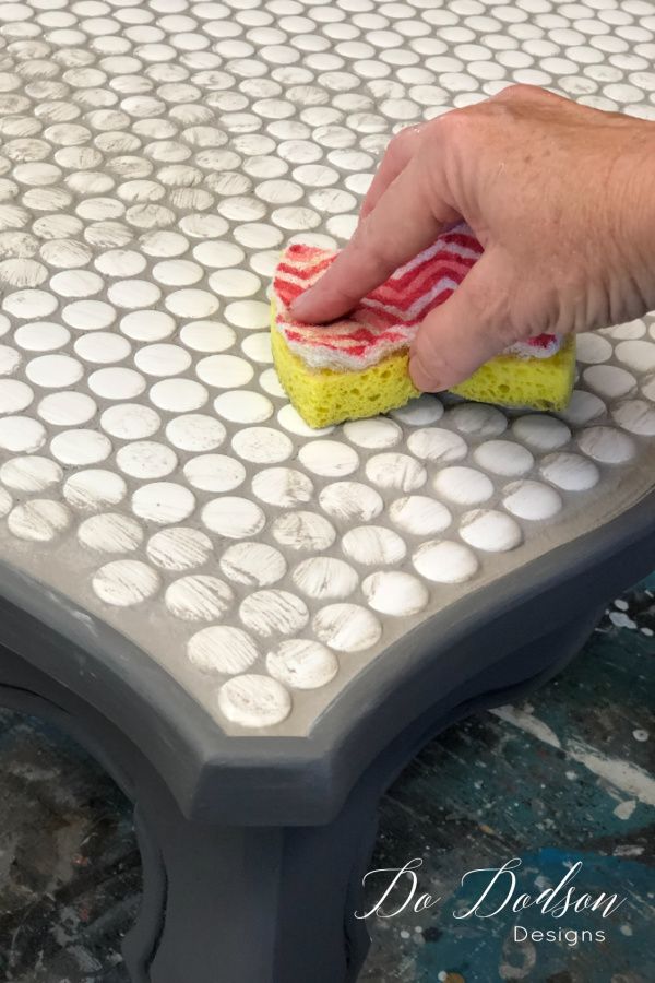 a person with a sponge on top of a table