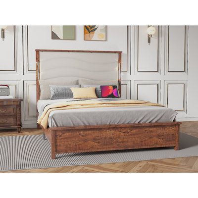 a bed sitting on top of a wooden floor next to a dresser with drawers under it