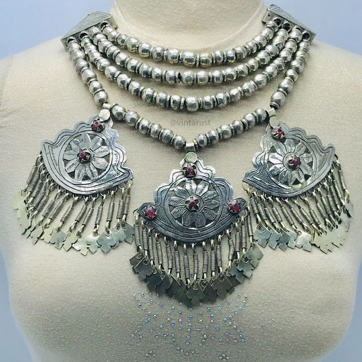 Massive Boho Beaded Chain Afghan Necklace. This multilayer silver beads tribal choker necklace has three vintage-inspired pendants which are making this tribal ornament an eye-pleasing jewelry piece. The best quality metal alloy is used to make this ethnic tribal piece. Glass stones and drooping silver tassels are increasing the charm and elegance of this tribal necklace. This Afghani tribal choker necklace gives a full ancestral and traditional look to you whenever you wear it. Bohemian Necklace With Silver Beads For Ceremonial Use, Silver Bohemian Beaded Necklaces, Traditional Silver Beaded Necklace, Bohemian Sterling Silver Beaded Chain Necklace, Traditional Long Silver Beaded Necklace, Bohemian Silver Beads Necklaces For Rituals, Bohemian Polished Beads Jewelry For Festival, Artisan Silver Beaded Necklaces For Festivals, Artisan Beaded Chain Jewelry For Festivals