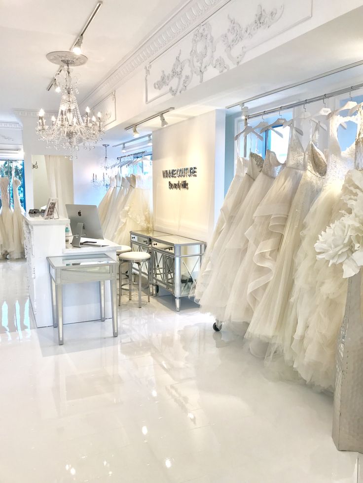 there are many wedding dresses on display in the store's showroom, including gowns