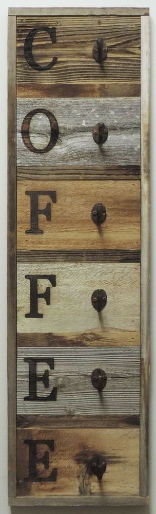 a wooden drawer with letters and numbers on the front, hanging on a wall in an art gallery