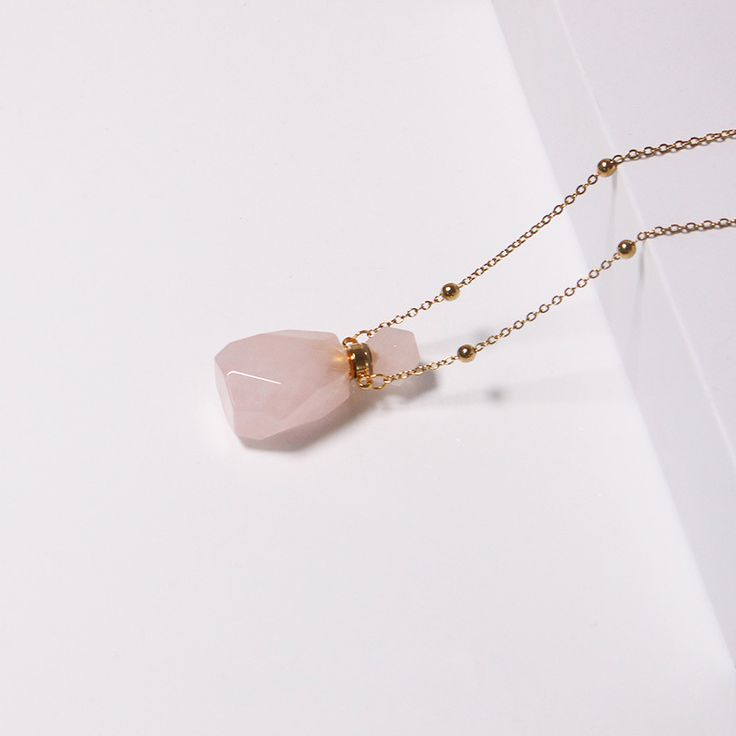 PLEASE NOTE: Our crystal stones are natural minerals and each crystal is unique. The internal ice cracks, pits, mineral points, and color differences of natural crystals are all formed naturally and are normal phenomena, which will not affect the efficacy, beauty and value of the crystal at all.This gorgeous rose quartz crystal bottle necklace will become part of your go-to jewelry! Each bottle is made of natural gemstones and minerals, connected by a stainless steel chain. You may fill the bott Rose Gold Rose Quartz Jewelry For Meditation, Healing Rose Quartz Gemstone Necklace, Rose Gold Crystal Necklaces For Jewelry Making, Rose Gold Crystal Necklaces With Rose Quartz Gemstone, Elegant Rose Quartz Crystal Necklace In Rose Gold, Pink Quartz Jewelry Gift, Pink Quartz Jewelry As A Gift, Pink Quartz Jewelry As Gift, Pink Quartz Jewelry For Gift