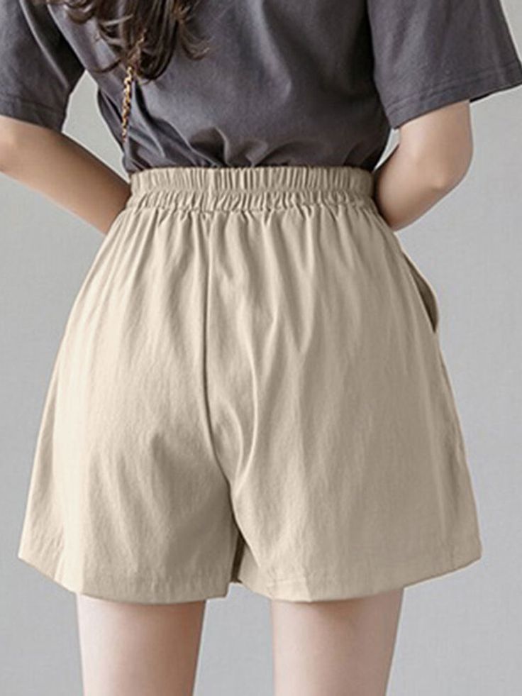 Solid Elastic Waist Button Pocket Casual Shorts High-waisted Solid Shorts With Buttons, Solid High-waisted Buttoned Shorts, Solid Color Buttoned High-waisted Shorts, Solid Color High-waisted Shorts With Buttons, Relaxed Fit Button-up Solid Bottoms, Trendy Solid Shorts With Button Closure, Trendy Solid Color Shorts With Button Closure, Casual Khaki Solid Color Shorts, Casual Beige Solid Color Shorts