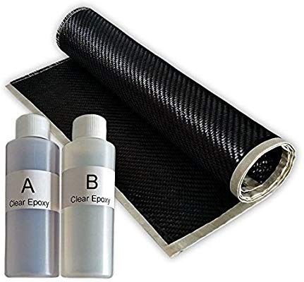 two bottles of air freshener next to a roll of black carbon cloth and silver foil