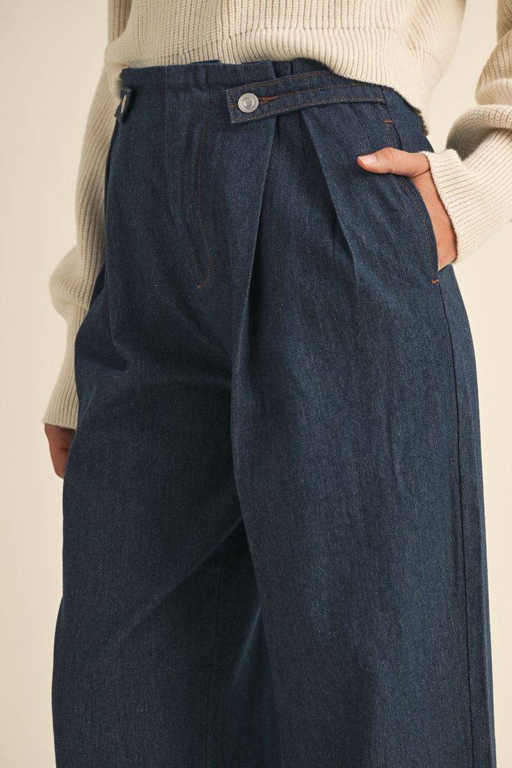 Discover effortless style with our new high-waist denim wide-leg pants. Featuring front pleats and button detailing, these pants offer a flattering silhouette and timeless appeal. Perfect for elevating your everyday look with a touch of classic sophistication. Sizing: Sm 2/4, Med 6/8, Lg 10 100% Rayon Fall Pleated Wide Leg Bottoms, Fall Wide Leg Pleated Bottoms, Pleated Wide Leg Bottoms For Fall, Fall Pleated High-waisted Pants, Elegant Denim Blue Bottoms With Pockets, Classic Dark Wash Wide Leg Pants, Dark Wash Wide Leg Bottoms With Welt Pockets, Wide Leg Dark Wash Bottoms With Welt Pockets, Elegant Wide Leg Relaxed Fit Jeans