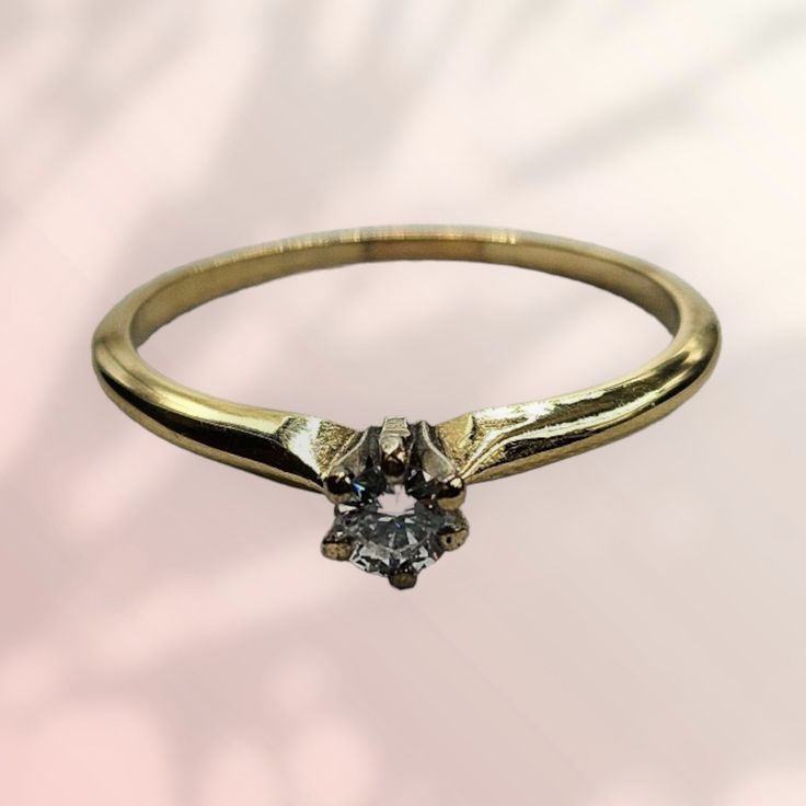 a gold ring with a diamond on it