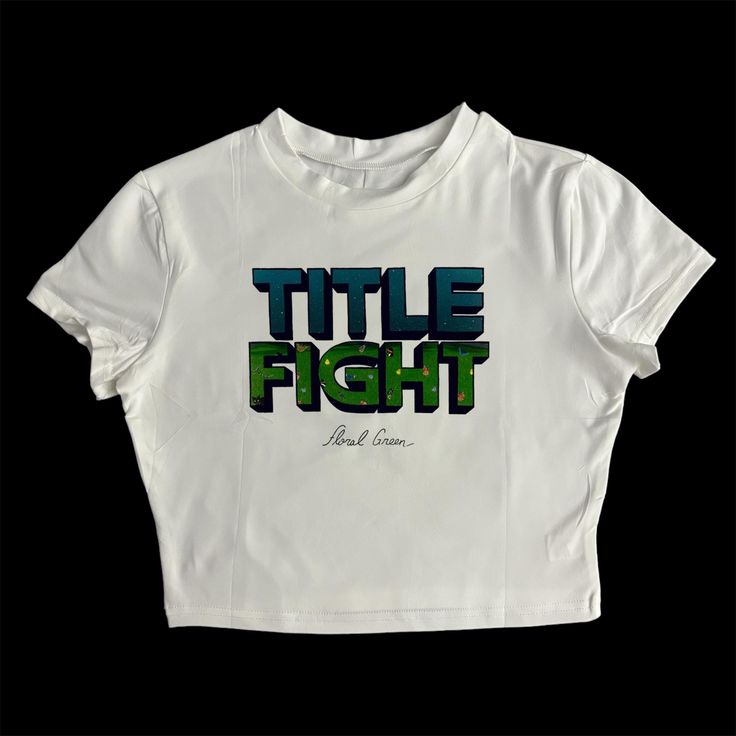 * Sublimated Title Fight band floral green cropped baby tee * Mannequin is wearing size XL * Mannequin measurements:    * Bust: 35" (C cup)    * Waist: 26"    * Hip: 40" * Soft, breathable, and stretchy material * For a looser fit, size up * Please note that all items are Made to Order & there may be slight variations in appearance Fitted Green T-shirt With Letter Print, Green Fitted T-shirt With Letter Print, Green Fitted Cropped T-shirt With Crew Neck, Green Crop Top For Streetwear, Streetwear Screen Print Cropped Top, Streetwear Crop Top With Screen Print, Slogan Crop Top T-shirt For Streetwear, Green Screen Print Tops For Streetwear, Streetwear Cropped Crop Top With Screen Print