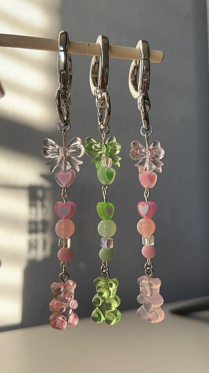 kawaii and fun colorful pink or green  gummy bear inspired key chain with bows & a heart shaped clasp. This is such a cute & fun piece to put on your accessory of choice, such as a handbag, backpack, keys, or even a water bottle (this fits on the Owala water bottle)  The charm is held together by jewelry wire, and a silver heart shaped clasp. This is the perfect gift or gift to self  No purse included, only comes with the keychain. The charms are single sided. Don't forget to favorite this listi Water Bottle Charms, Bead Keychain Ideas, Key Chains Aesthetic, Beaded Keychain Ideas, Gummy Bear Keychain, Green Gummy Bear, Beaded Keyrings, Cute Key Chains, Owala Water Bottle