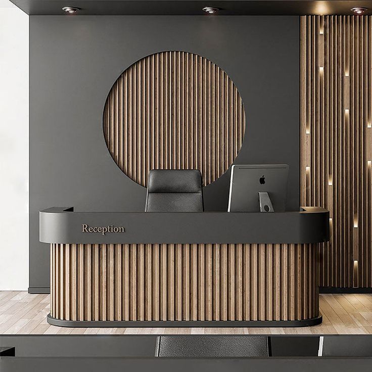 the reception desk has a laptop on it in front of a circular wooden paneled wall