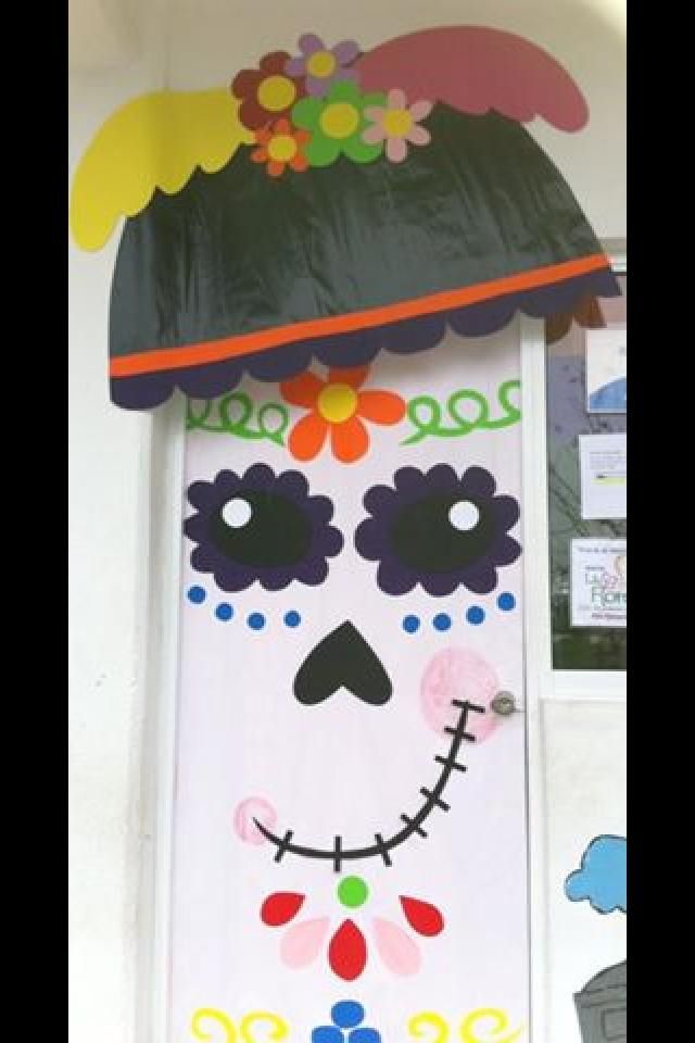 a door decorated to look like a skeleton with a hat on it's head