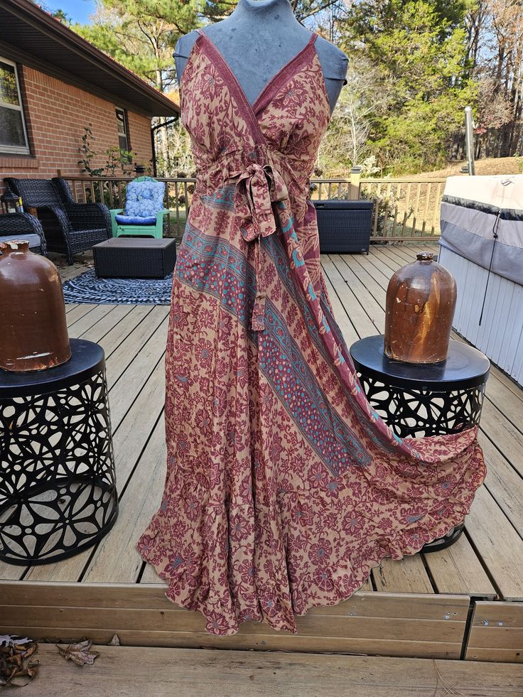 "This is a beautiful empire waist maxi dress , one of a kind handcrafted from vintage silk . Has a V neck , adjustable straps and smocked at the back . Measurement (appx): Bust:  36 \" with elastic waist stretch upto 42\" Height: 56 \"( measured from the shoulder line to the bottom ) ONE size fits most from S to L ,please refer to the measurements before purchasing . Has a tie by the bust for a chic look . Thank you looking , stay safe !" Brown V-neck Maxi Dress For Festival, Bohemian V-neck Maxi Dress With Smocked Back, Bohemian Maxi Dress With Empire Waist For Vacation, Bohemian Empire Waist Maxi Dress For Vacation, Bohemian Halter Neck Maxi Dress With Tie Back, Bohemian Floor-length Maxi Dress With Tie Back, Sleeveless Bohemian Maxi Dress With Smocked Back, Flowy Bohemian Dress With Empire Waist, Flowy Lined Maxi Sundress