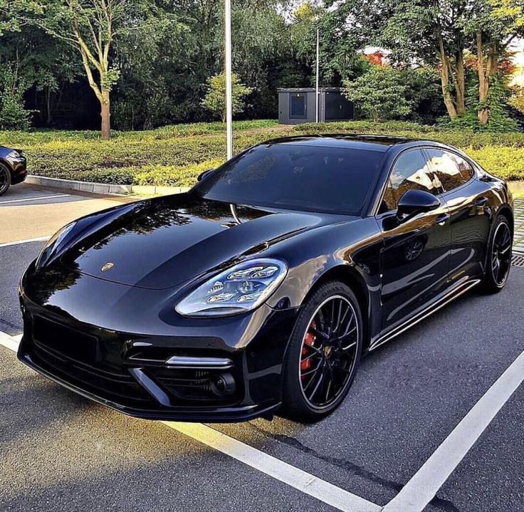 a black sports car parked in a parking lot