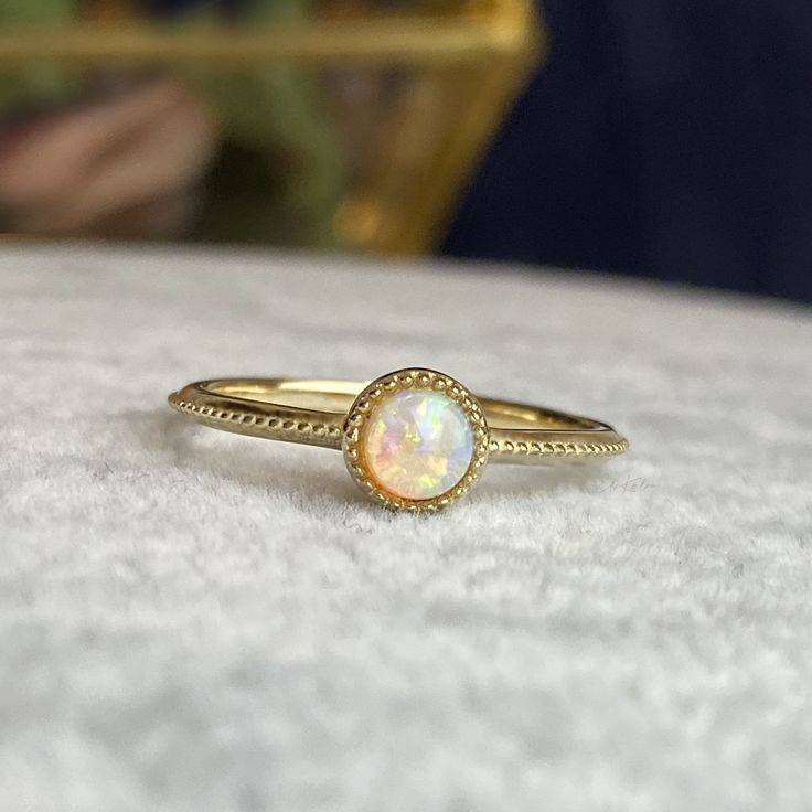 Handcrafted in 14K solid gold, features a 4mm round cab natural opal bezel set in a beautiful milgrain vintage style setting. A great everyday stacking ring or alternative gemstone engagement ring for your loved one! 🛠️ Setting: ✔️Metal Purity: 14K Solid Gold ✔️Color:  Yellow ✔️Band width: 1.5mm ✔️Ring sits 2.7mm on the finger 💎Center Stone: ✔️Stone: Natural Opal ✔️Shape: Round Cabochon ✔️Size: 4mm ✔️Carat: 0.25ct ❤️Visit our official website for exclusive new products.      https://elekalonjewelry.com/ ❤️Follow us on Instagram @ elekalonjewelry for the latest projects and much more! ❤️If you have any questions, please feel free to message us. . Gold Round Cut Opal Ring, Gold Opal Birthstone Ring, Gold Opal Ring With Birthstone, Gold Opal Ring Adjustable, Gold Adjustable Opal Ring, Round Shape, Adjustable Gold Opal Ring, Gold Opal Ring Fine Jewelry, Opal Ring With Bezel Setting, Opal Ring With Bezel Setting For Promise