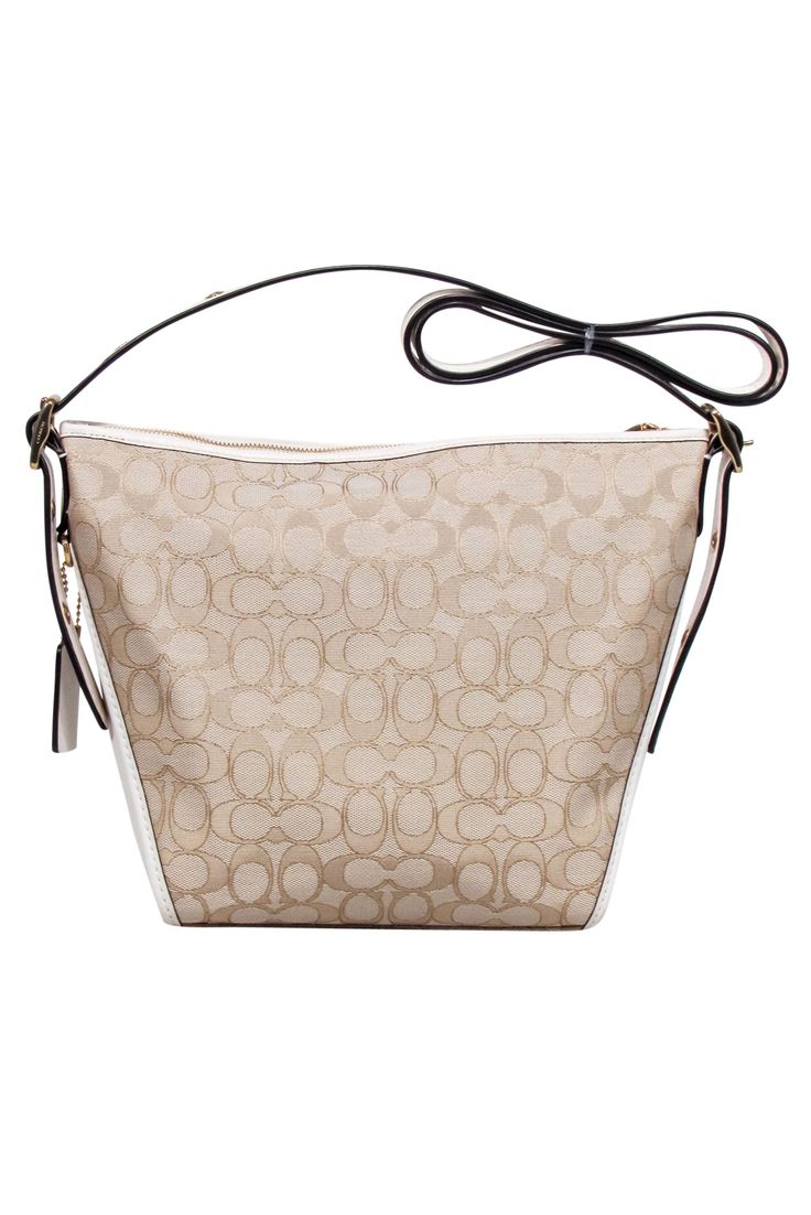 Stay polished and prepared on-the-go with the Coach "Jacquard Dufflette" Bag. The custom-woven jacquard and smooth leather trim exude luxury, while the gold-tone hardware adds a touch of elegance. The versatile beige and cream color scheme makes this shoulder bag perfect for any busy fashionista. Woven jacquard Leather trim Gold-tone hardware Adjustable strap Top zipper Internal slip & zipper pocket Dust bag included Height 10" Width 12" Depth 2.5" Strap drop 22" Luxury Coated Canvas Hobo Bag With Leather Handles, Luxury Hobo Bag With Leather Handles And Coated Canvas, Elegant Monogram Canvas Shoulder Bag With Adjustable Strap, Chic Shoulder Bag With Detachable Strap In Monogram Canvas, Chic Monogram Canvas Shoulder Bag With Detachable Strap, Chic Monogram Canvas Bags, Everyday Bucket Bag In Monogram Canvas With Gold-tone Hardware, Everyday Monogram Canvas Bucket Bag With Gold-tone Hardware, Gold Signature Coated Canvas Bag For Everyday