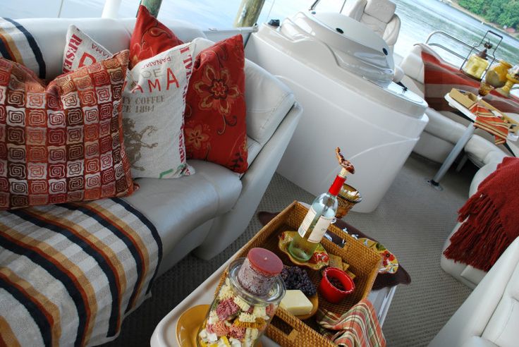 a living room filled with lots of furniture and pillows