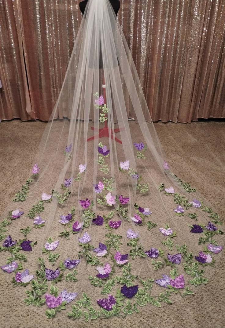 a wedding veil with purple flowers on it